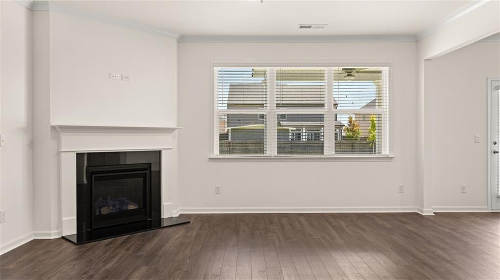 71 Weymouth Drive Locust Grove, GA 30248 - Photo 17 of 56 a view of an empty room with wooden floor and a window