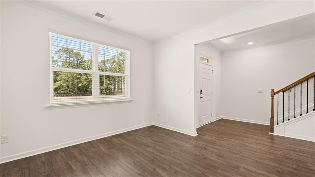 71 Weymouth Drive Locust Grove, GA 30248 - Photo 23 of 56 a view of an empty room with wooden floor and a window