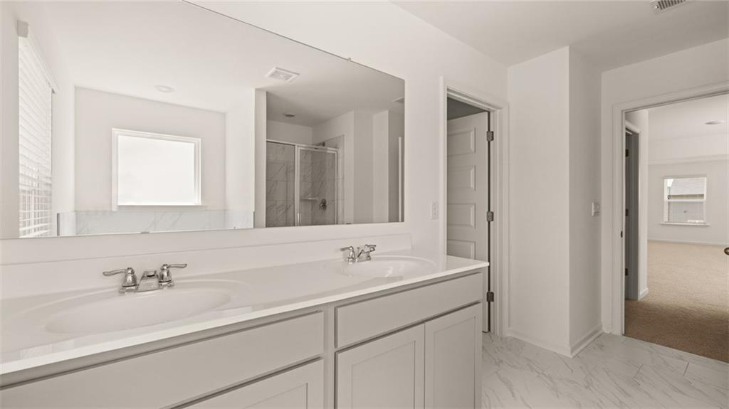 71 Weymouth Drive Locust Grove, GA 30248 - Photo 37 of 56 a bathroom with double sink and a mirror