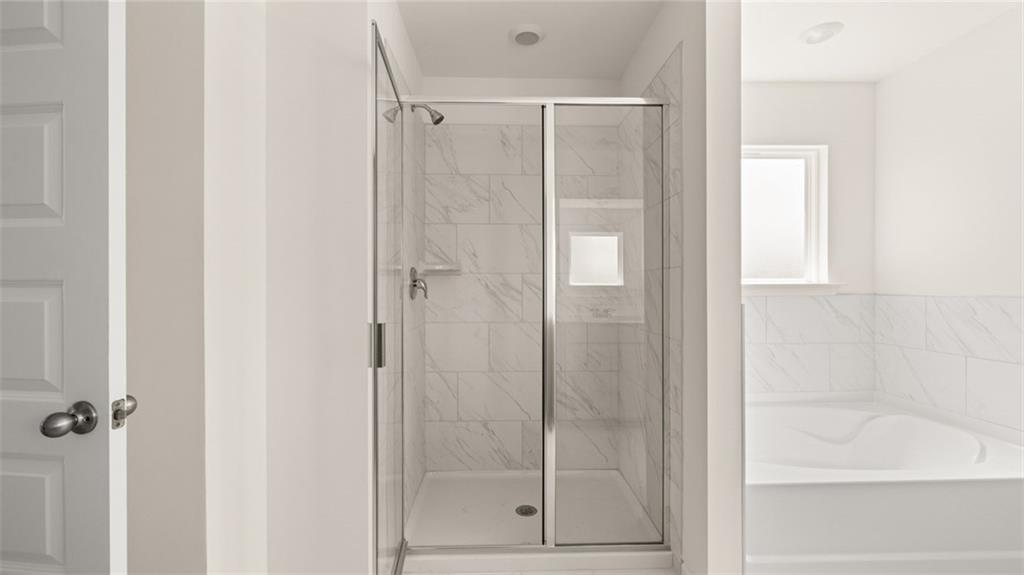 71 Weymouth Drive Locust Grove, GA 30248 - Photo 39 of 56 a bathroom with a glass shower door