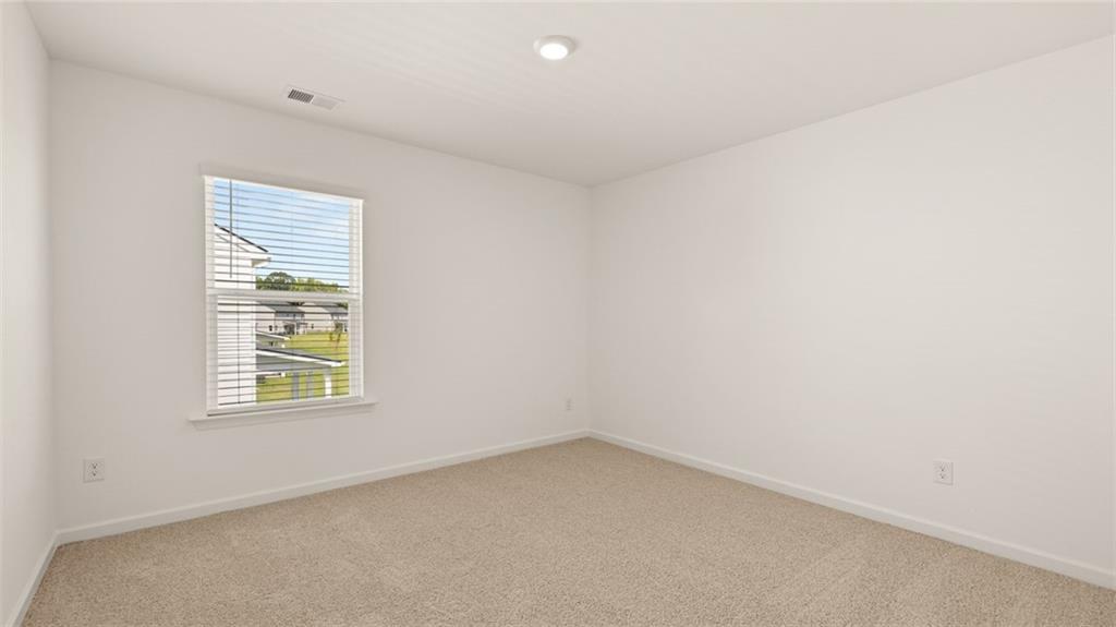 71 Weymouth Drive Locust Grove, GA 30248 - Photo 49 of 56 an empty room with a window