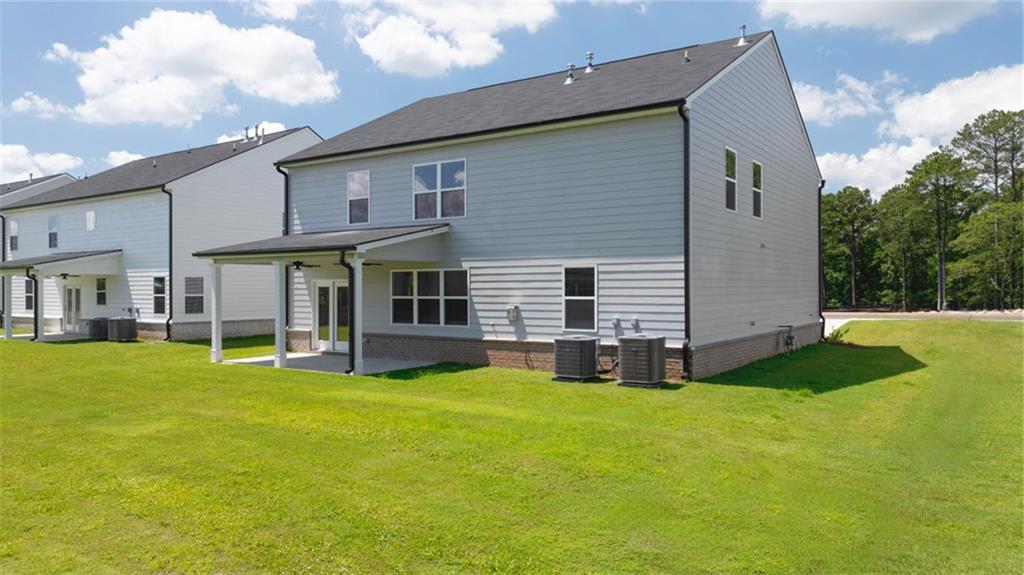 71 Weymouth Drive Locust Grove, GA 30248 - Photo 54 of 56 a view of a house with a yard and sitting area