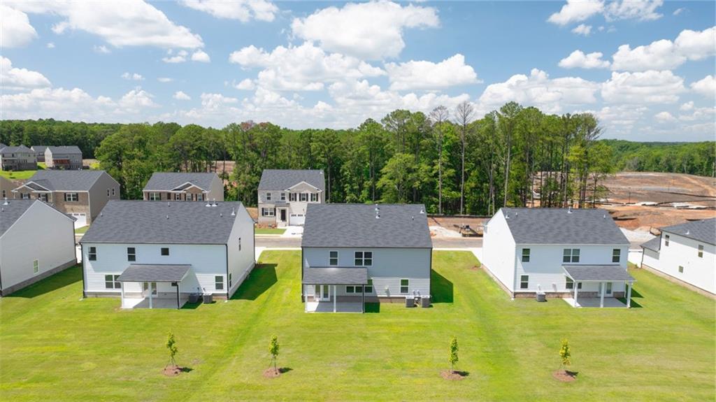 71 Weymouth Drive Locust Grove, GA 30248 - Photo 56 of 56 an aerial view of residential houses with outdoor space and trees