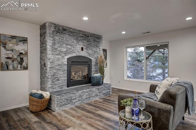 7790 Julynn Road Colorado Springs, CO 80919 - Photo 34 of 50 Beautiful gas fireplace with stone surround and raised hearth.