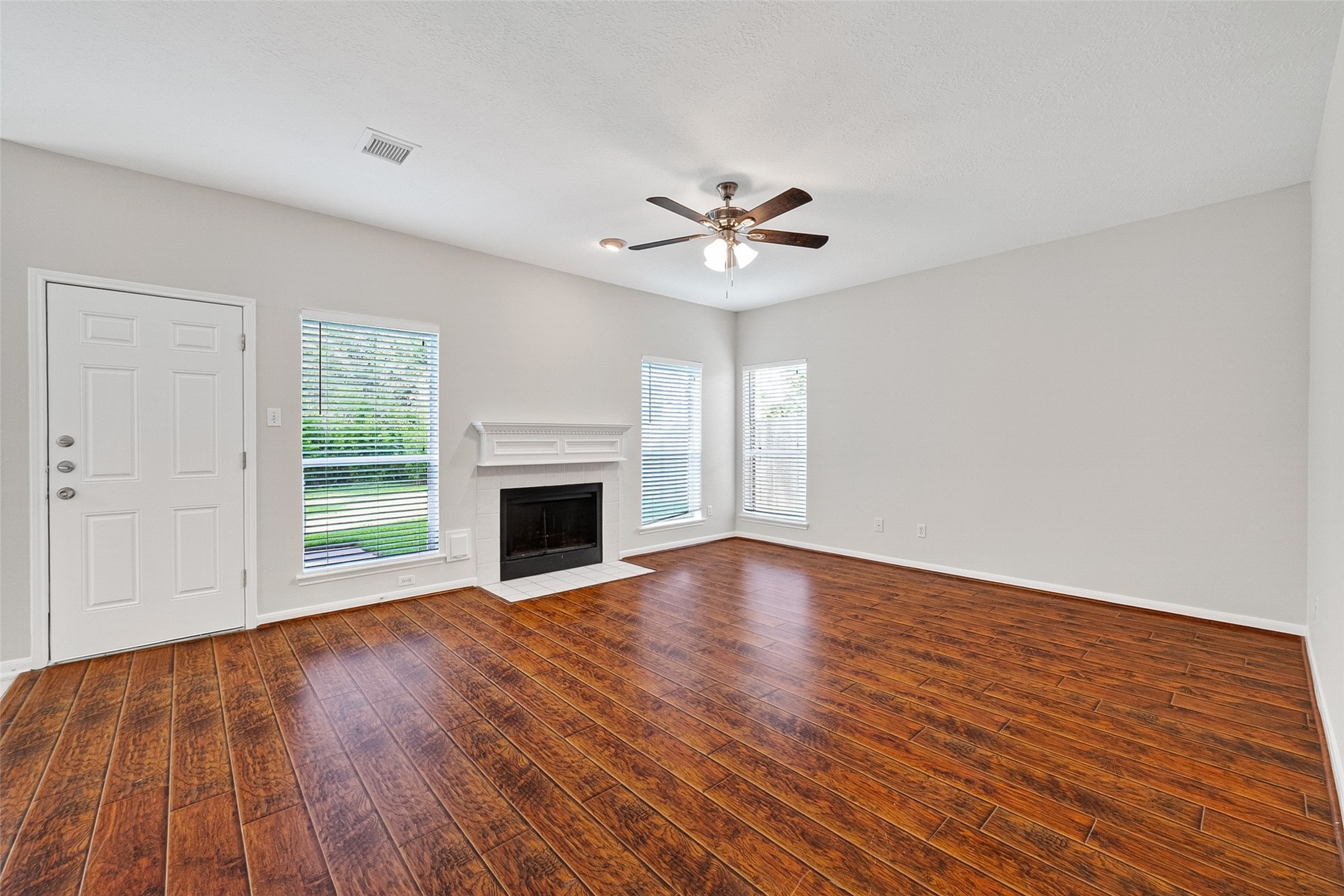 4539 Springfield Lakes Street Sugar Land, TX 77479 - Photo 15 of 34 a view of empty room with wooden floor and fireplace
