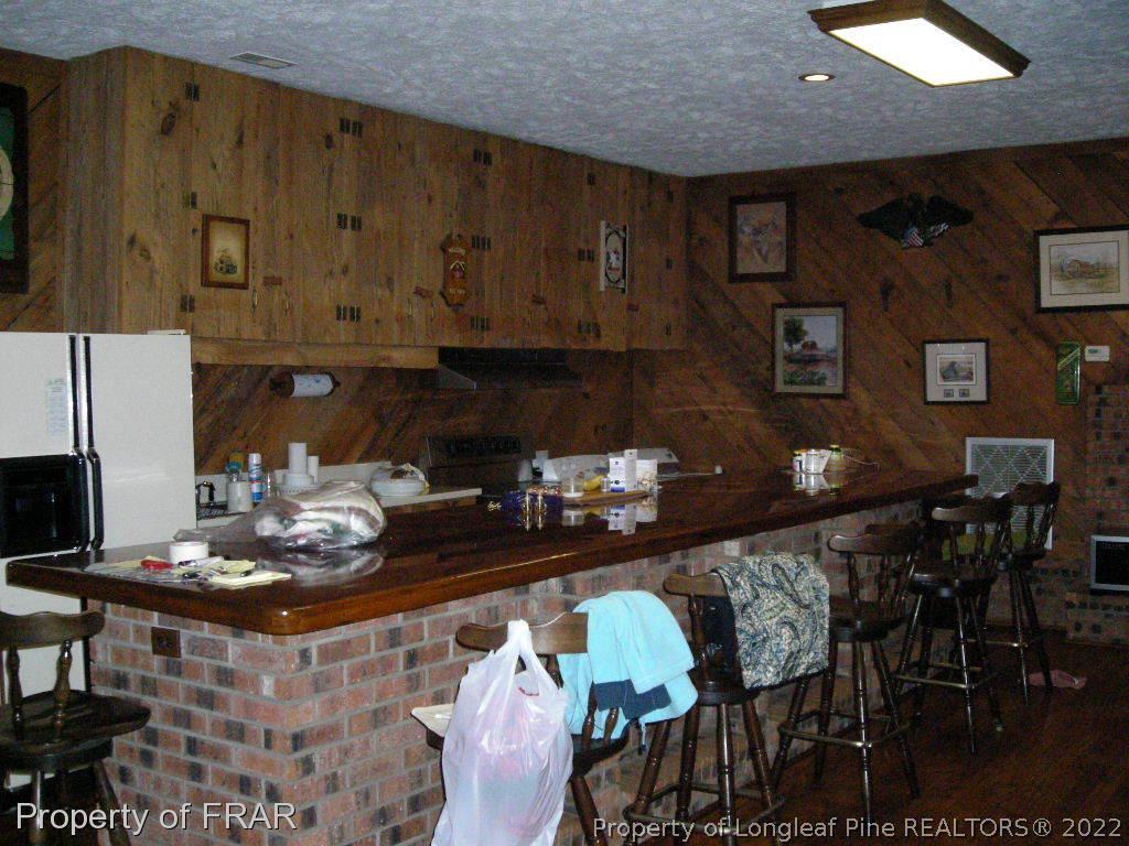 5310 Lovette Road Orrum, NC 28369 - Photo 15 of 31 a kitchen with a stove and chairs