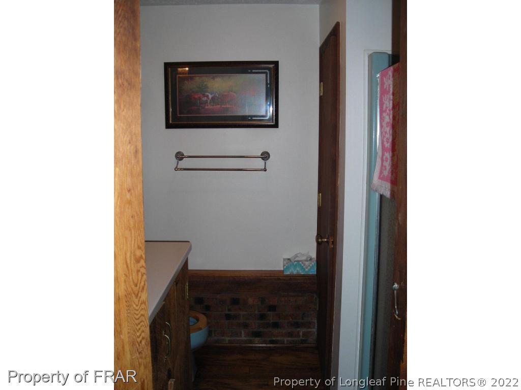 5310 Lovette Road Orrum, NC 28369 - Photo 17 of 31 a living room with a bed and a flat screen tv