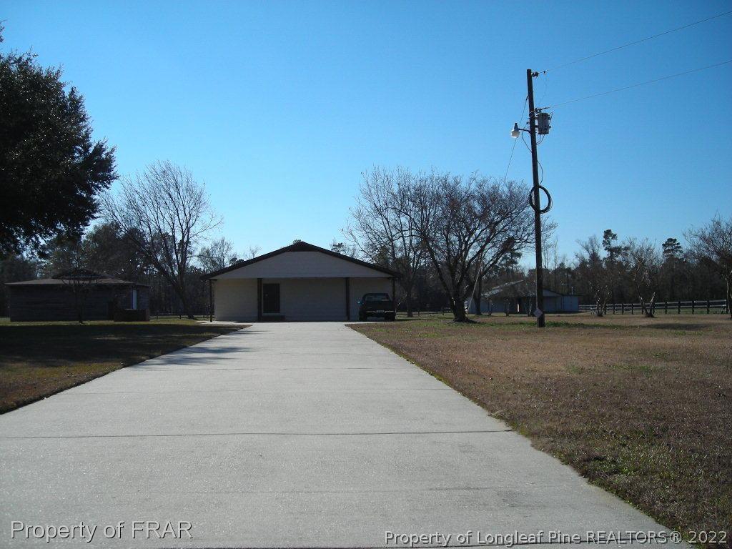 5310 Lovette Road Orrum, NC 28369 - Photo 29 of 31 a tall building with trees in the background