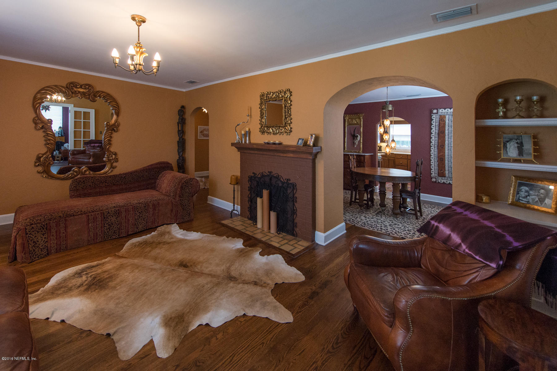 824 South Shores Road Jacksonville, FL 32207 - Photo 5 of 19 a living room with furniture a fireplace and a chandelier