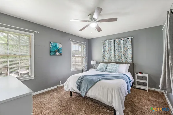 a bedroom with a bed and a table