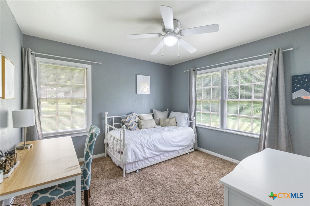 1609 South 39th Street Temple, TX 76504 - Photo 14 of 19 a bedroom with a bed and a table