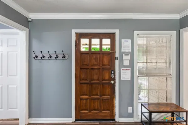 a view of a room with cabinet wooden floor and windows