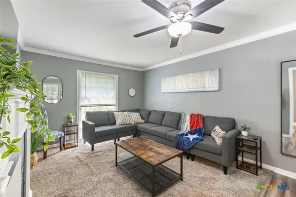 a living room with furniture and a large window