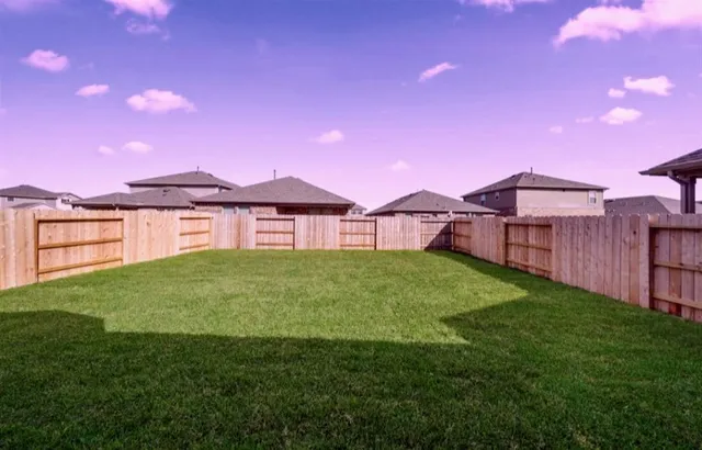 a view of a yard with a house in the background