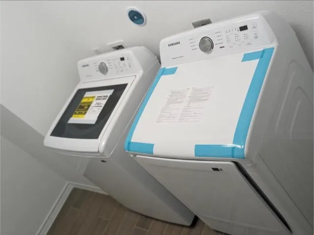 view of living room with baby crib and dresser