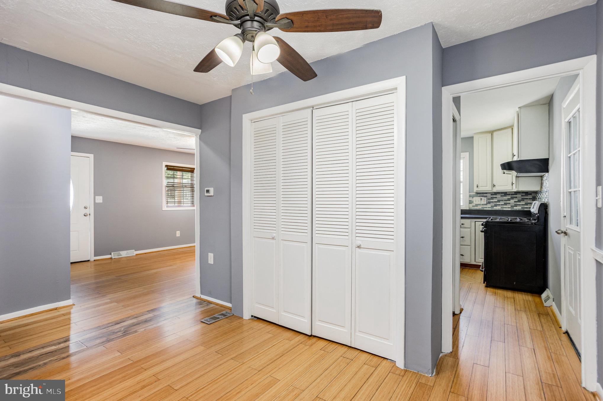 615 Pinehurst Street Aberdeen, MD 21001 - Photo 12 of 39 an empty room with wooden floor cabinet and a ceiling fan
