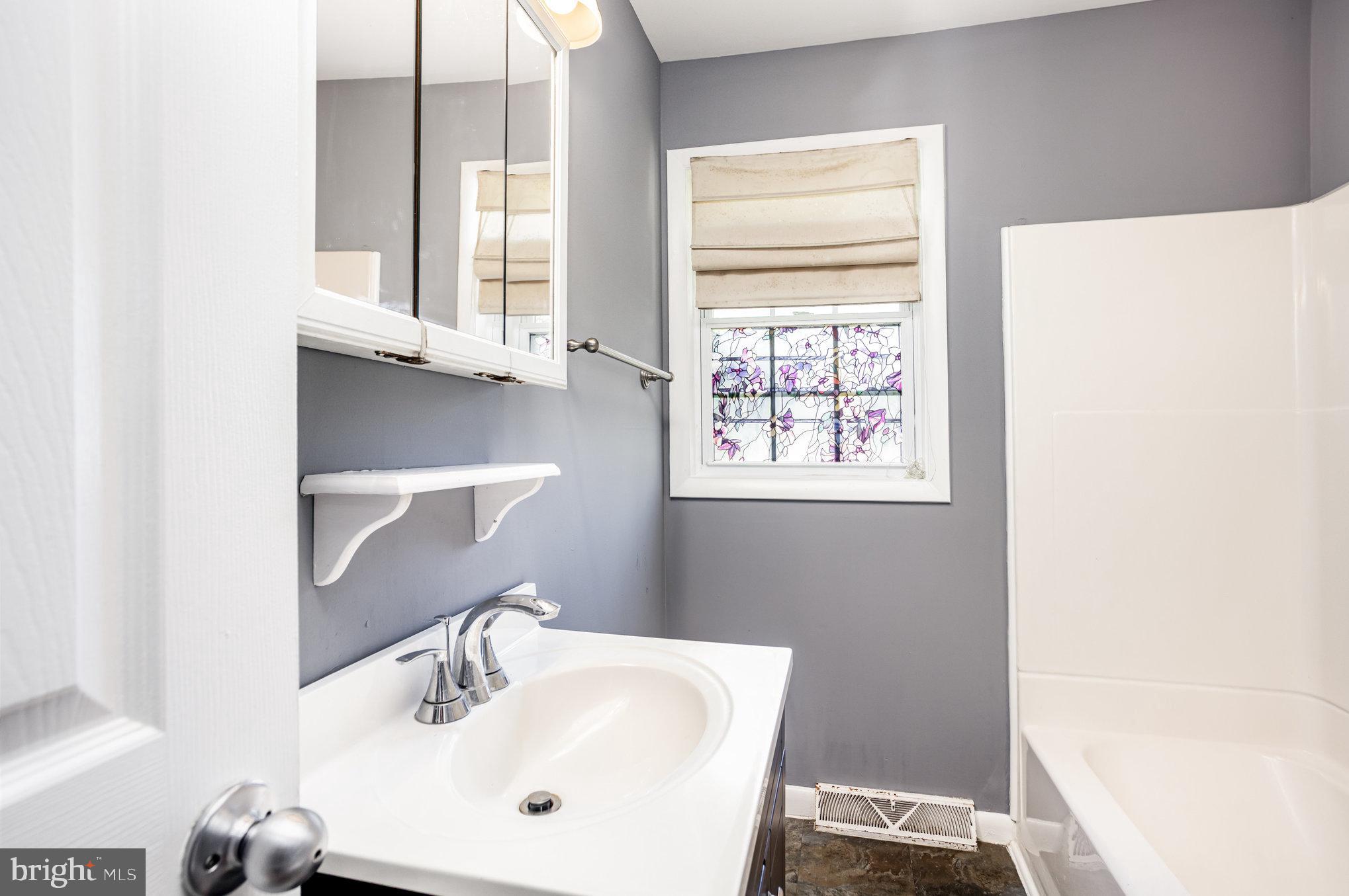 615 Pinehurst Street Aberdeen, MD 21001 - Photo 16 of 39 a bathroom with a sink and a window
