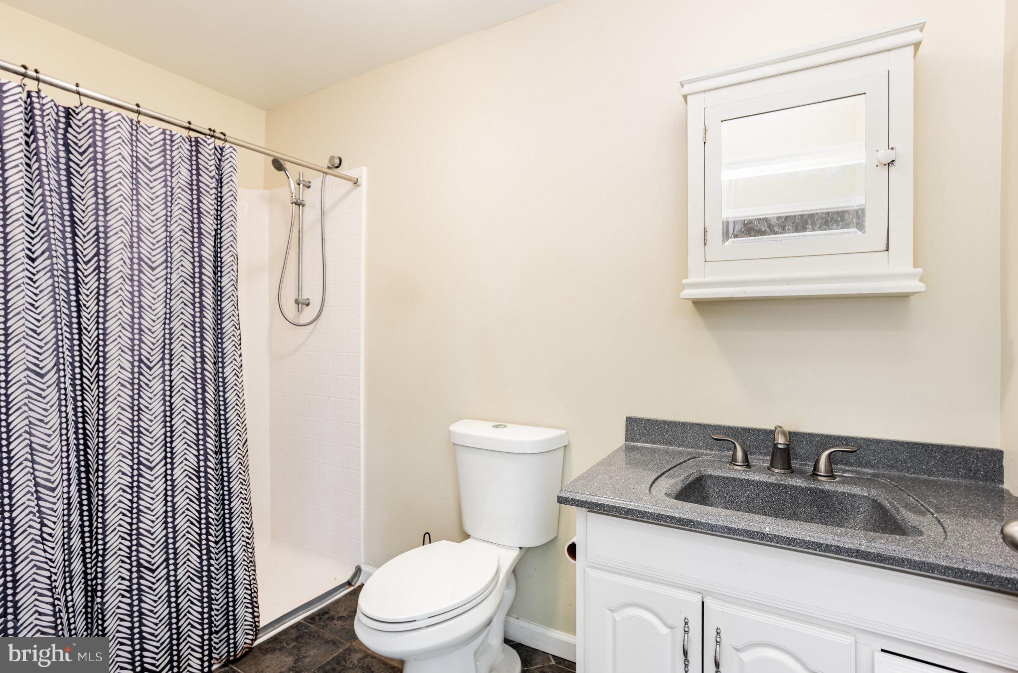 615 Pinehurst Street Aberdeen, MD 21001 - Photo 27 of 39 a bathroom with a granite countertop sink toilet and shower