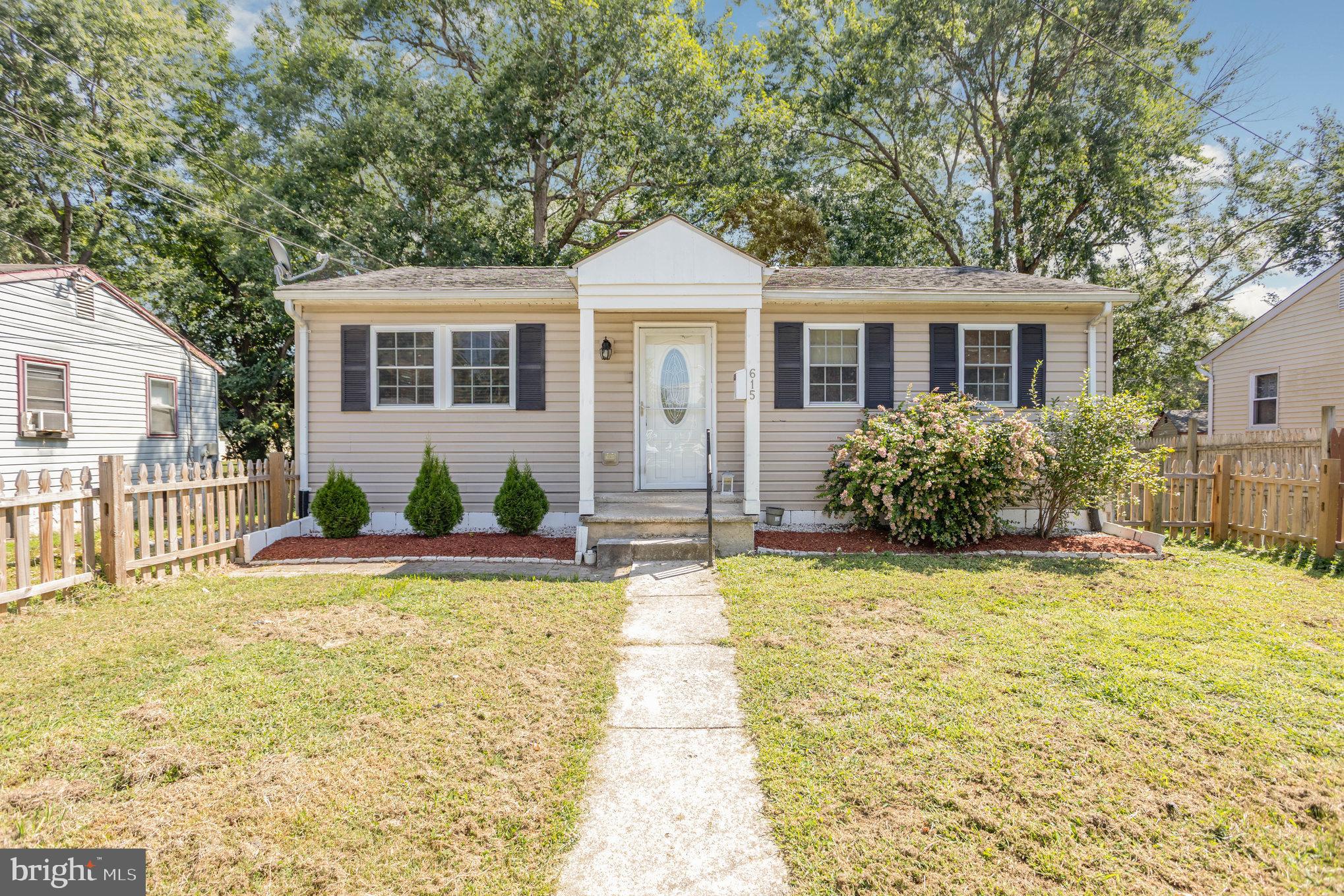 615 Pinehurst Street Aberdeen, MD 21001 - Photo 3 of 39 a front view of a house with a yard and potted plants