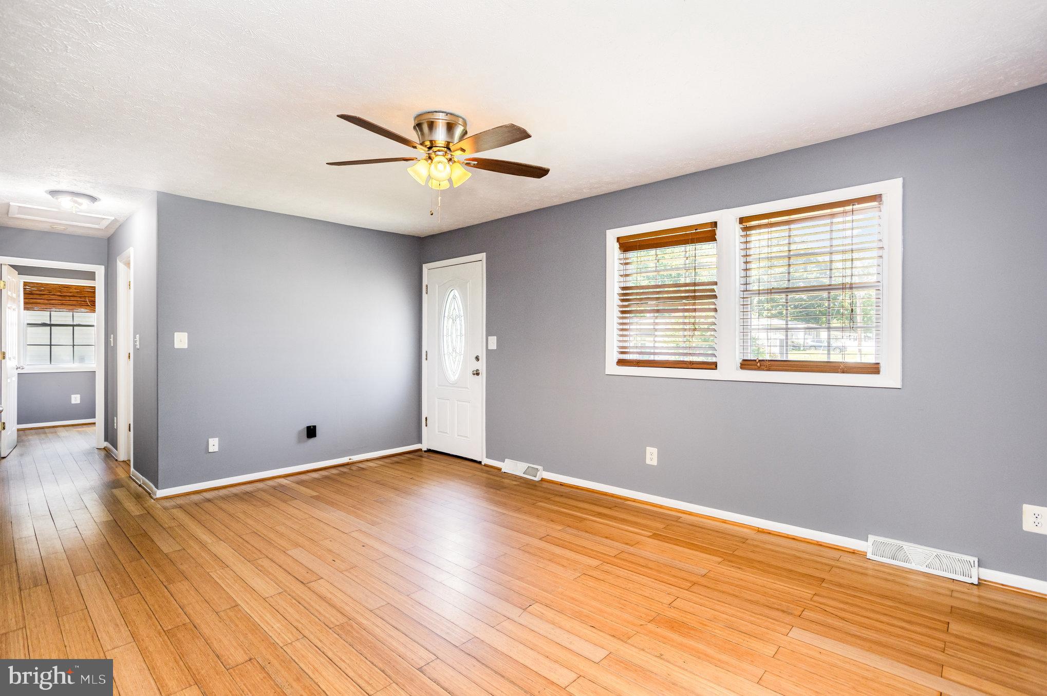 615 Pinehurst Street Aberdeen, MD 21001 - Photo 5 of 39 a view of an empty room with wooden floor and a window