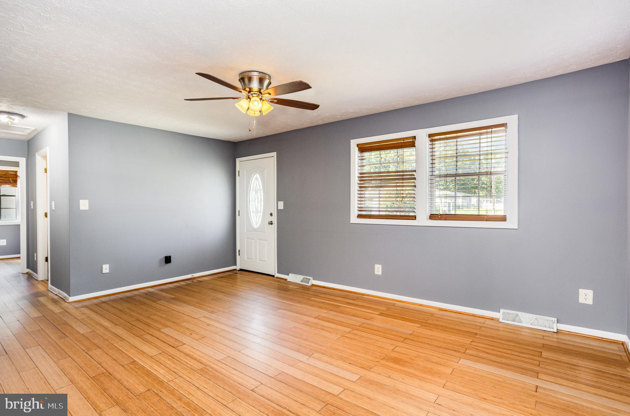 615 Pinehurst Street Aberdeen, MD 21001 - Photo 6 of 39 a view of an empty room with window and wooden floor