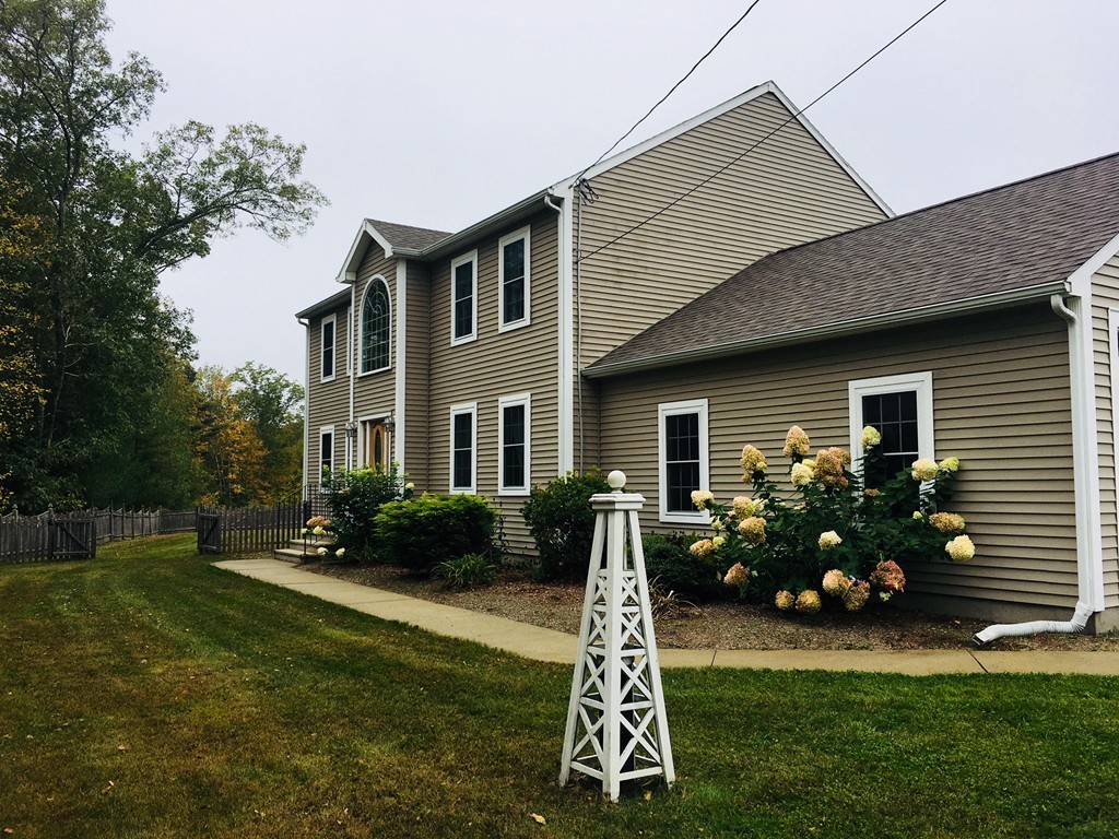 10 Baker Pond Road Charlton, MA 01507 - Photo 1 of 21 a front view of house with yard and green space