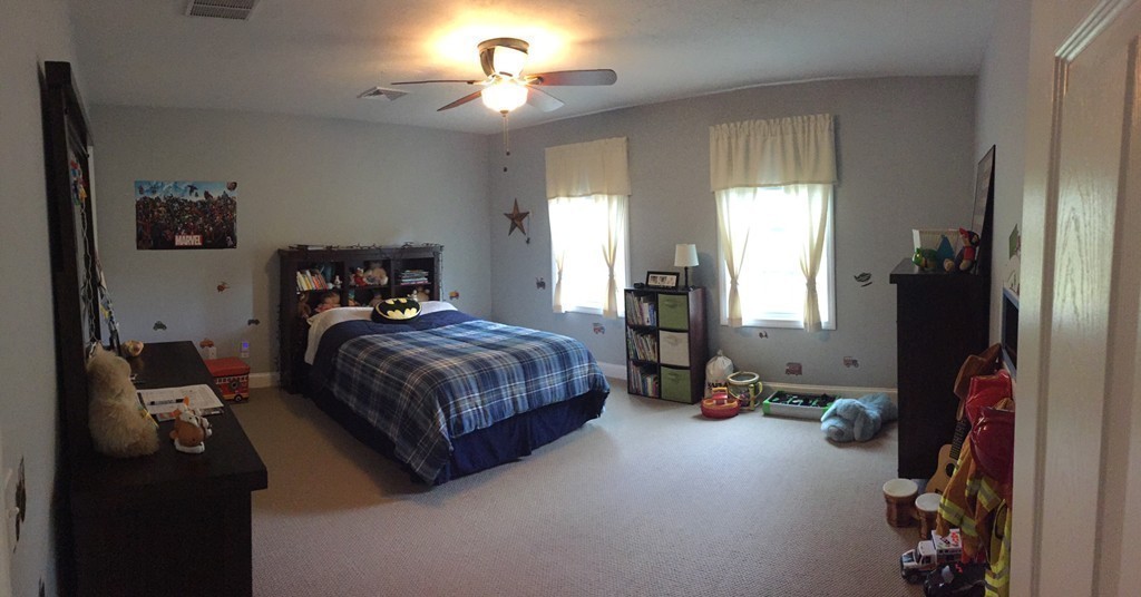 10 Baker Pond Road Charlton, MA 01507 - Photo 18 of 21 a bedroom with a bed and a chandelier