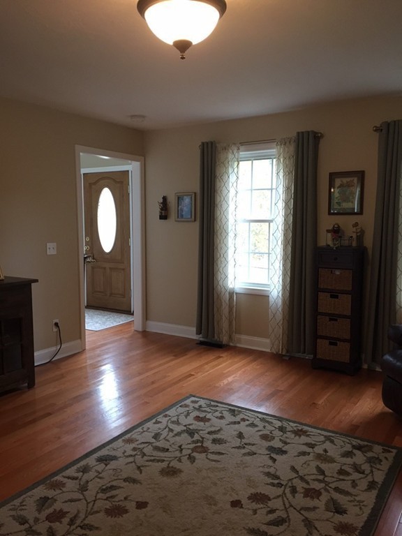 10 Baker Pond Road Charlton, MA 01507 - Photo 3 of 21 a view of an empty room with window and wooden floor