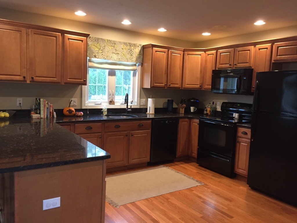 10 Baker Pond Road Charlton, MA 01507 - Photo 6 of 21 a kitchen with stainless steel appliances granite countertop a sink a stove a refrigerator cabinets and a window