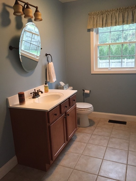 10 Baker Pond Road Charlton, MA 01507 - Photo 10 of 21 a bathroom with a sink a toilet and a mirror