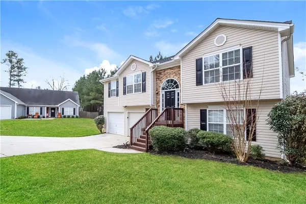 a front view of a house with a yard