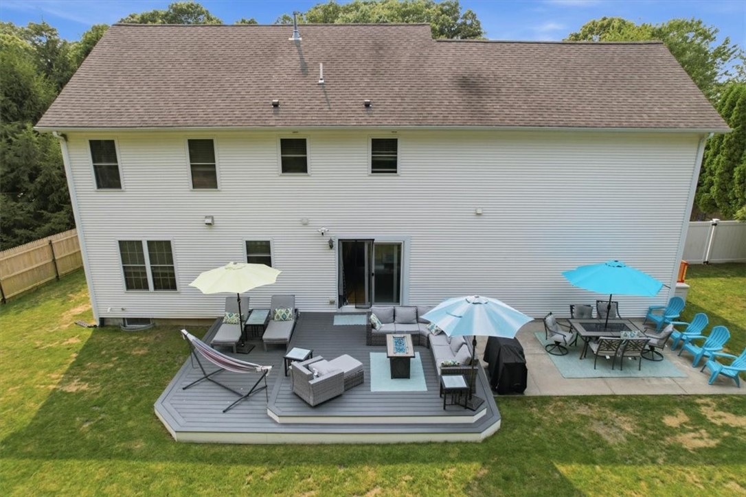 26 Davis Circle Warwick, RI 02886 - Photo 44 of 50 Surrounded by mature trees for added privacy, this is a backyard where you'll enjoy summer barbecues, morning coffee, family gatherings, and evenings under the stars.