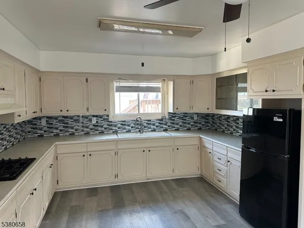 a kitchen with granite countertop white cabinets and white appliances