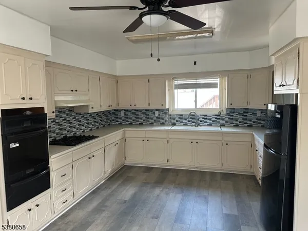 a kitchen with granite countertop white cabinets white stainless steel appliances with a sink and dishwasher