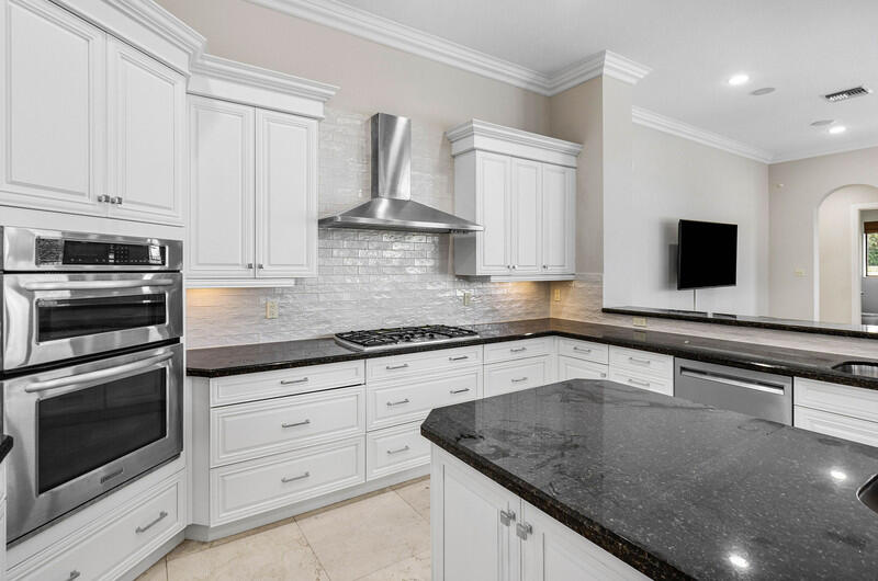 17895 Cadena Drive Boca Raton, FL 33496 - Photo 14 of 49 a kitchen with granite countertop white cabinets and stainless steel appliances