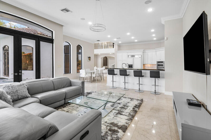 17895 Cadena Drive Boca Raton, FL 33496 - Photo 17 of 49 a living room with furniture and a flat screen tv