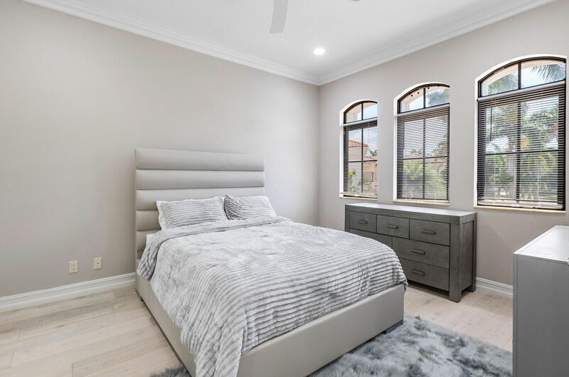 17895 Cadena Drive Boca Raton, FL 33496 - Photo 31 of 49 a bedroom with a large bed and two windows