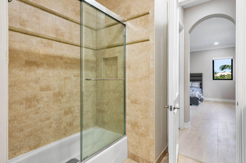 17895 Cadena Drive Boca Raton, FL 33496 - Photo 32 of 49 a bathroom with a glass shower door