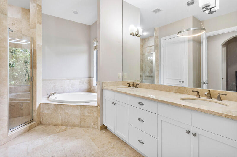 17895 Cadena Drive Boca Raton, FL 33496 - Photo 39 of 49 a spacious bathroom with a double vanity sink toilet mirror and bathtub