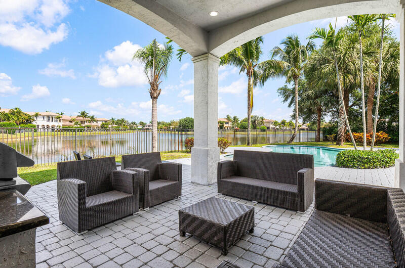 17895 Cadena Drive Boca Raton, FL 33496 - Photo 45 of 49 a view of swimming pool with outdoor seating and a garden