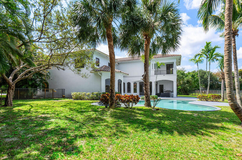 17895 Cadena Drive Boca Raton, FL 33496 - Photo 47 of 49 a view of a backyard with a garden and palm trees