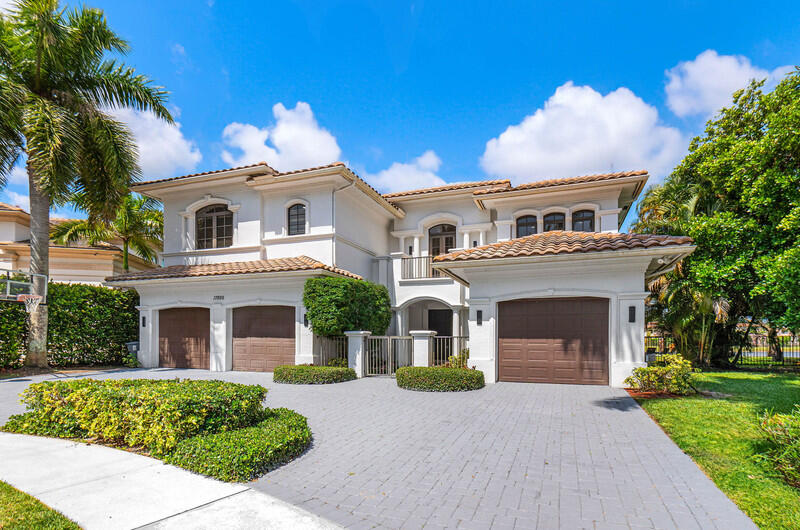 17895 Cadena Drive Boca Raton, FL 33496 - Photo 5 of 49 a front view of a house with a yard and garage