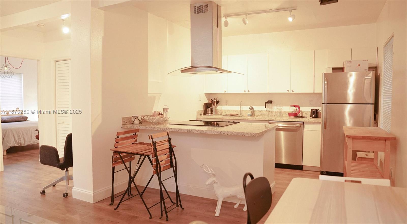 68 Northwest 45th Street, Unit 2 Miami, FL 33127 - Photo 16 of 20 a kitchen with appliances a sink and cabinets