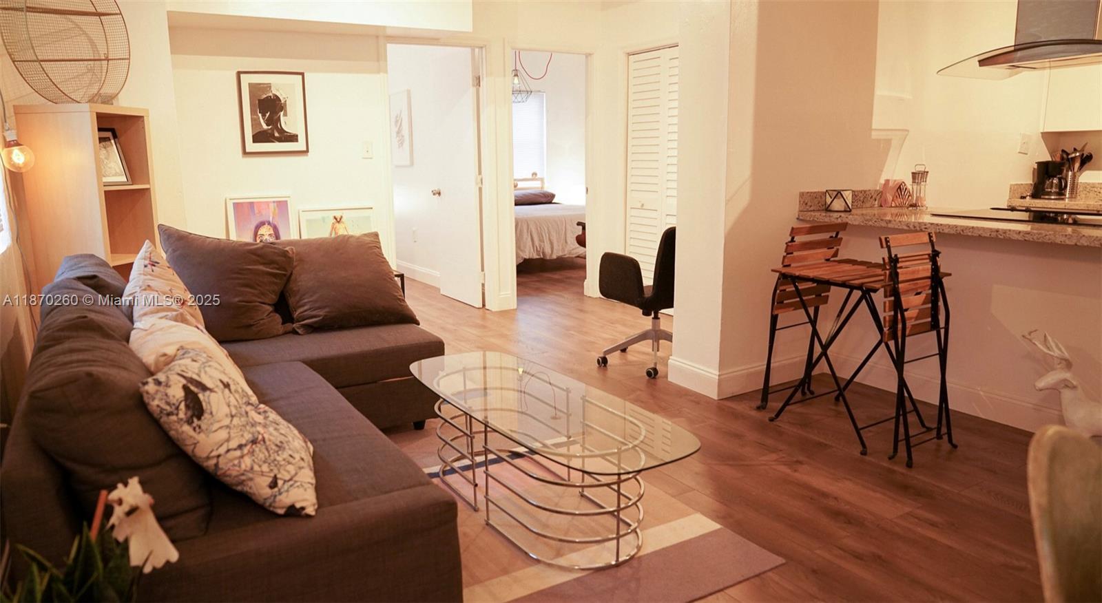 68 Northwest 45th Street, Unit 2 Miami, FL 33127 - Photo 20 of 20 a living room with furniture and a wooden floor