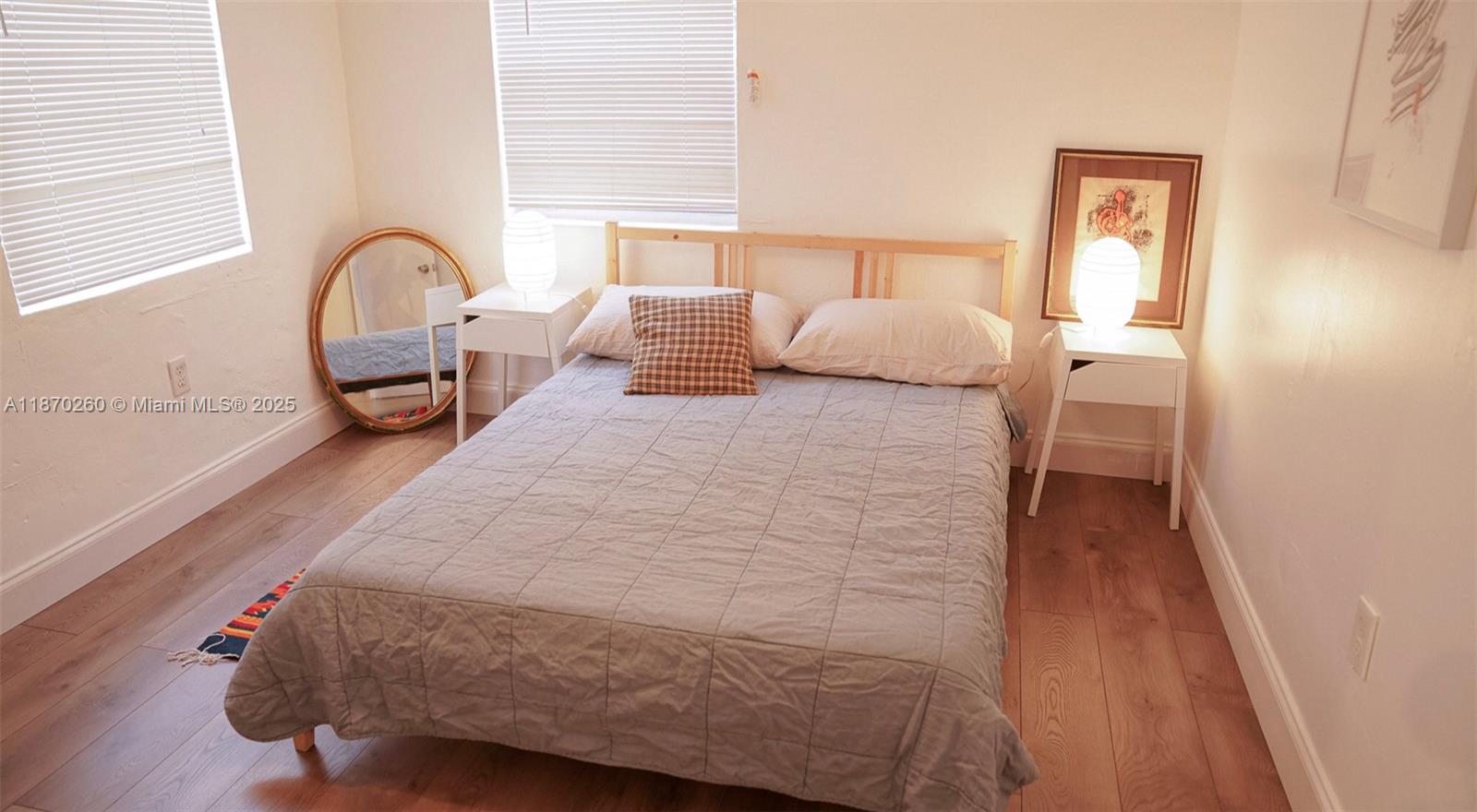 68 Northwest 45th Street, Unit 2 Miami, FL 33127 - Photo 7 of 20 a bedroom with a bed next to a window with outer view and couch