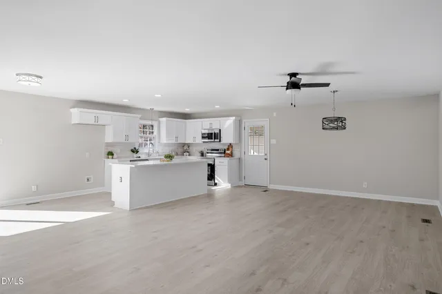 a view of a kitchen with wooden floor