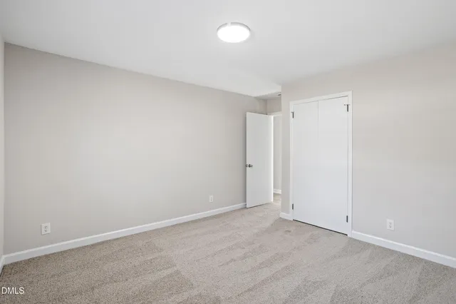 a front view of a house with a garden and yard