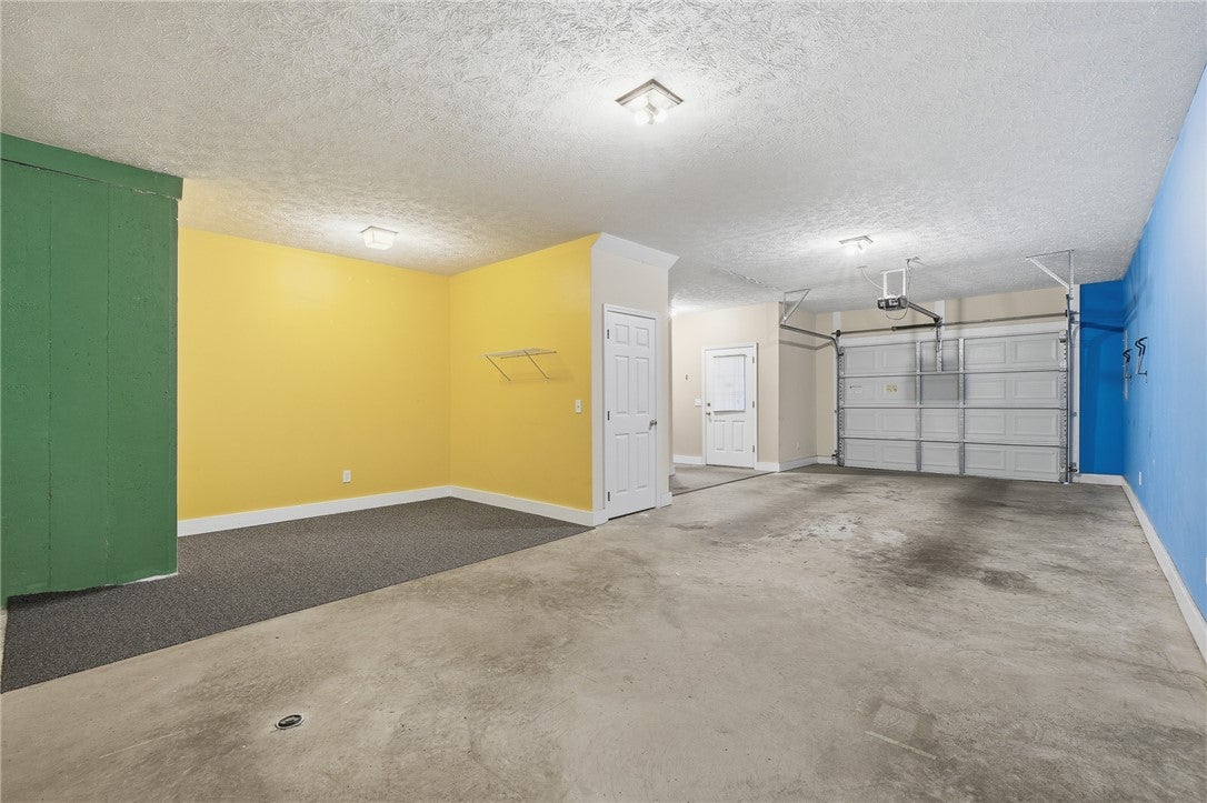 1213 North Dean Road Auburn, AL 36830 - Photo 16 of 18 This spacious garage offers versatile space to park 2 vehicles, stacked. And additional recreational space for a workshop, gym, etc.