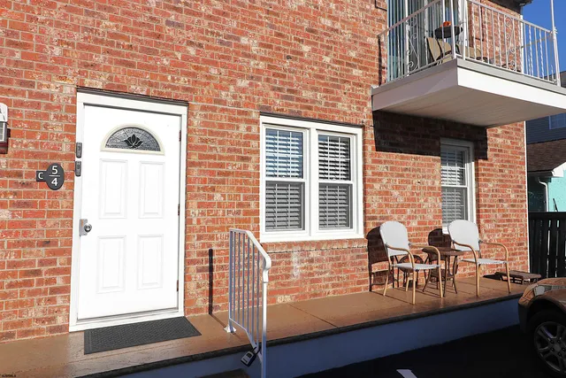 a view of a two chairs in the balcony