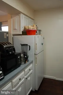 a kitchen with a refrigerator and cabinets